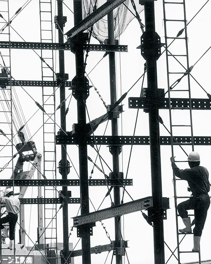Workers climbing girders