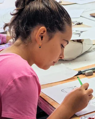 Teen girl creating illustration at the Art School