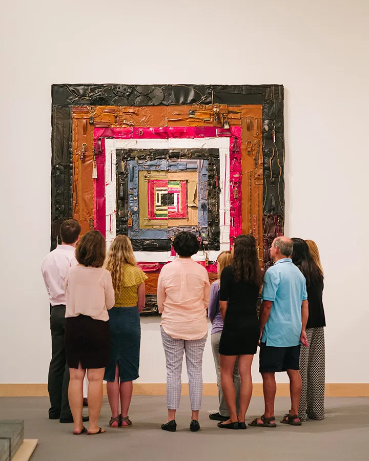 Group of museum visitors enjoying paintings