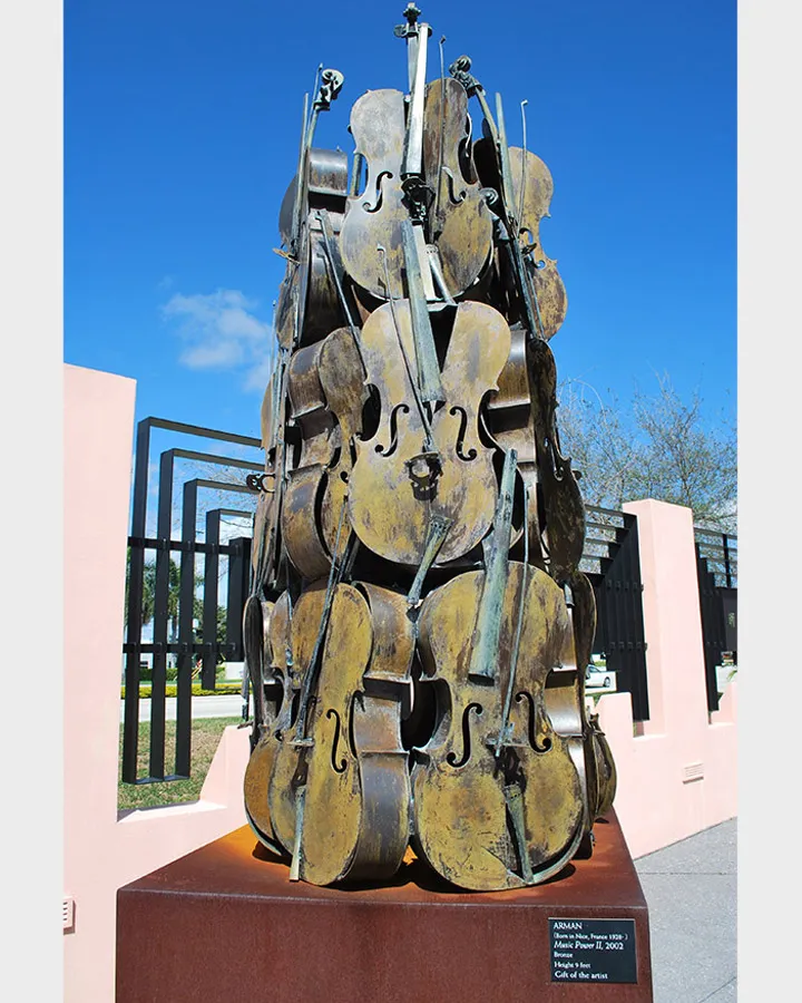Bronze violins piled into a tower.