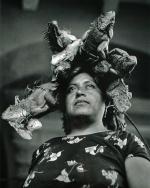 Woman with iguanas on her head. 