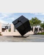 Large black steel cube tilted on axis.