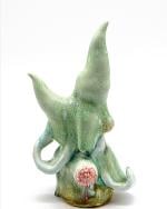 Ceramic sculpture of a green organic form. 