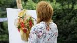 Woman painting on easel