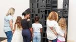 Parents and kids admiring sculpture