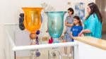 Museum visitors admiring glass sculptures