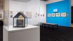 Sculpture of a house and photographs of birds.