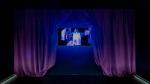 Video flanked by purple curtains