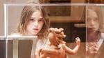 Young girl mesmerized by sculpture