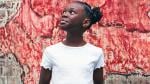 Young girl posing in front of painting