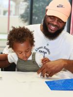 Father doing art activity with his young child.