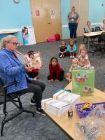 Teacher reading at Art Tales